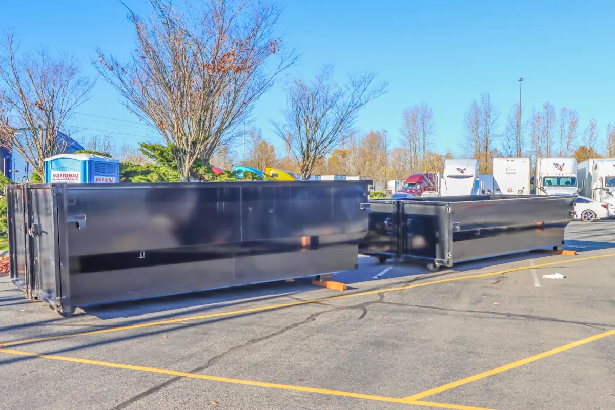 Professional dumpster rental service with roll-off container on residential driveway in Wake Forest